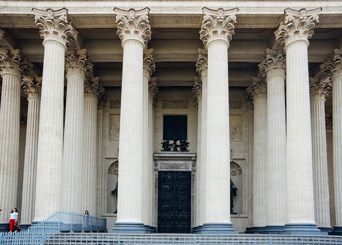 Facade of a classical building with large columns and ornate capitals.