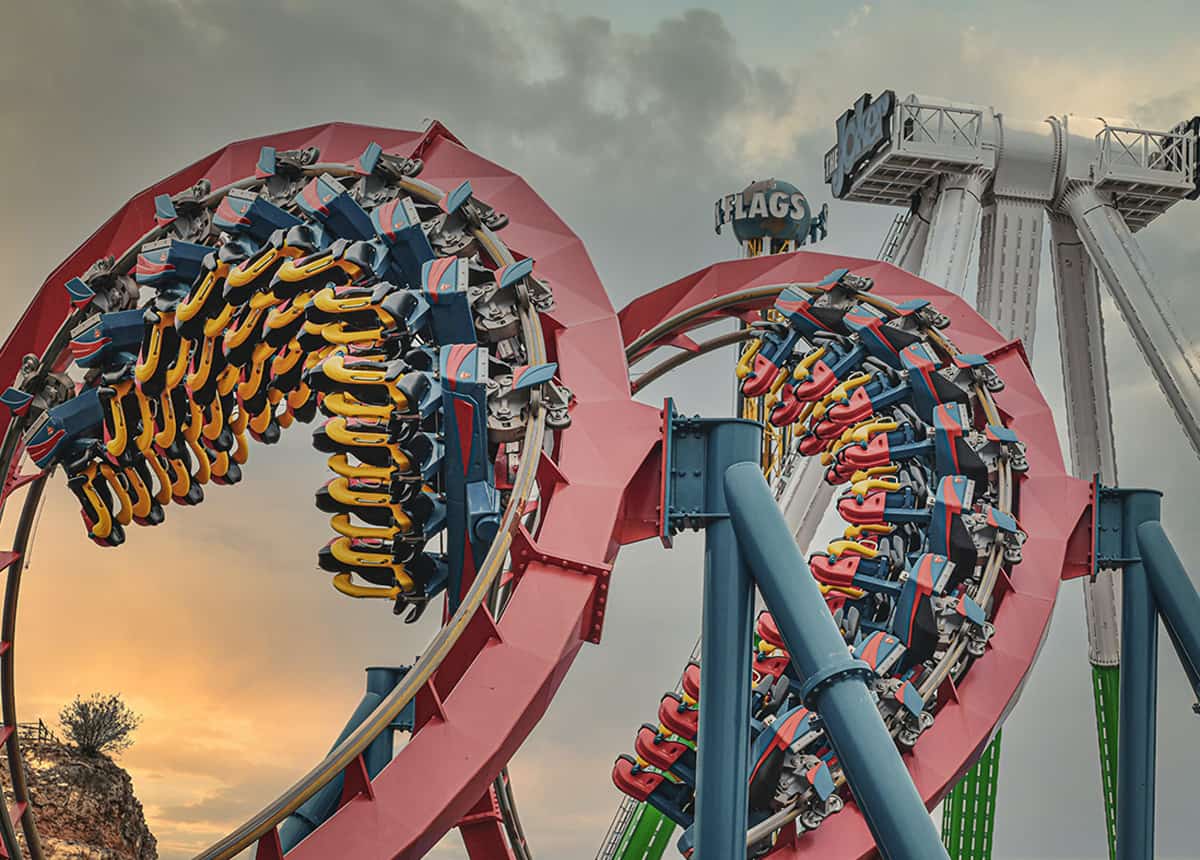 Photo of a roller coaster at Six Flags amusement park during sunset.